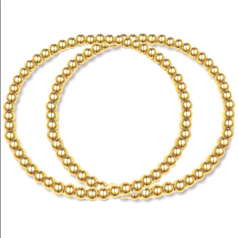 Two 4 mm stackable gold bracelets in pouch